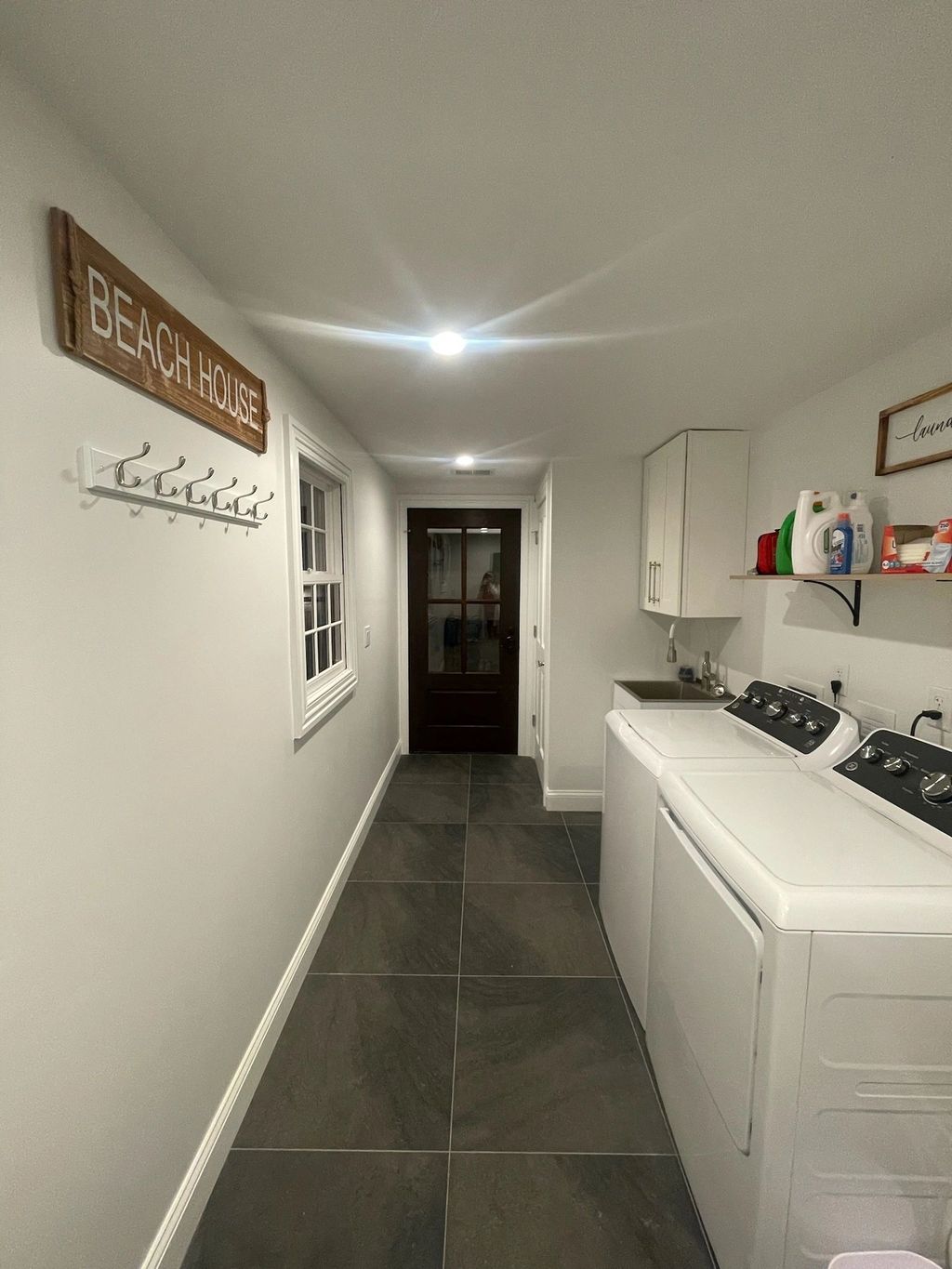 Mudroom hallway with washer and dryer